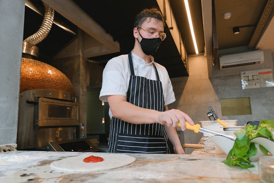 Pizza chef skillfully preparing handcrafted dough in a professional kitchen